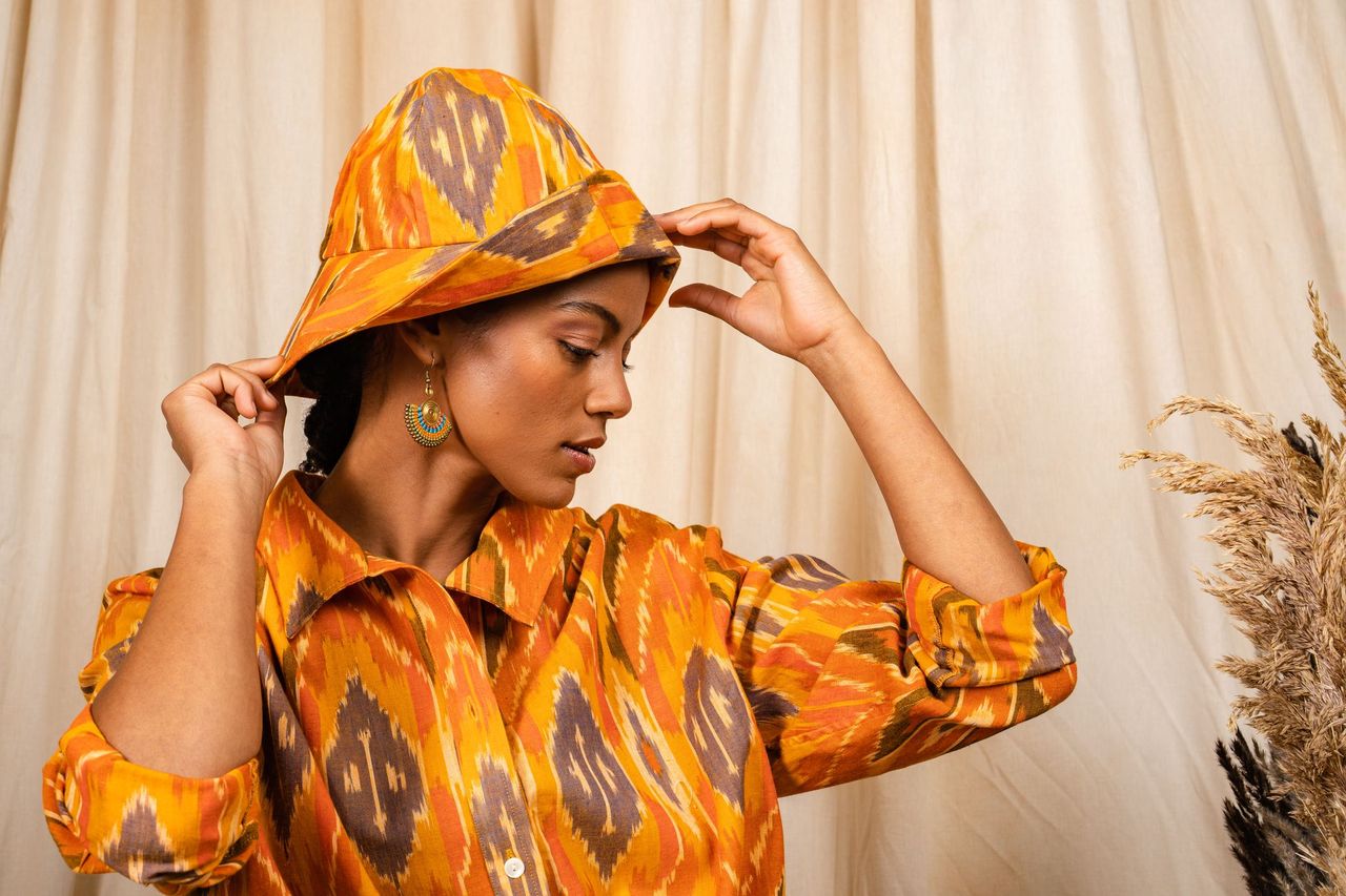 handmade-clothing: woman-wearing-ikat-shirt-and-hat